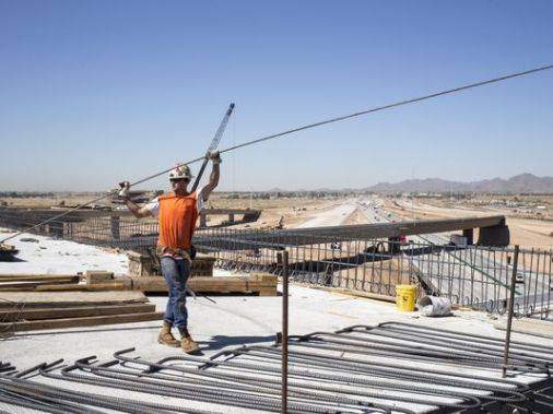 Workers construct Loop 303 freeway. Mark Henle/azcentral.com